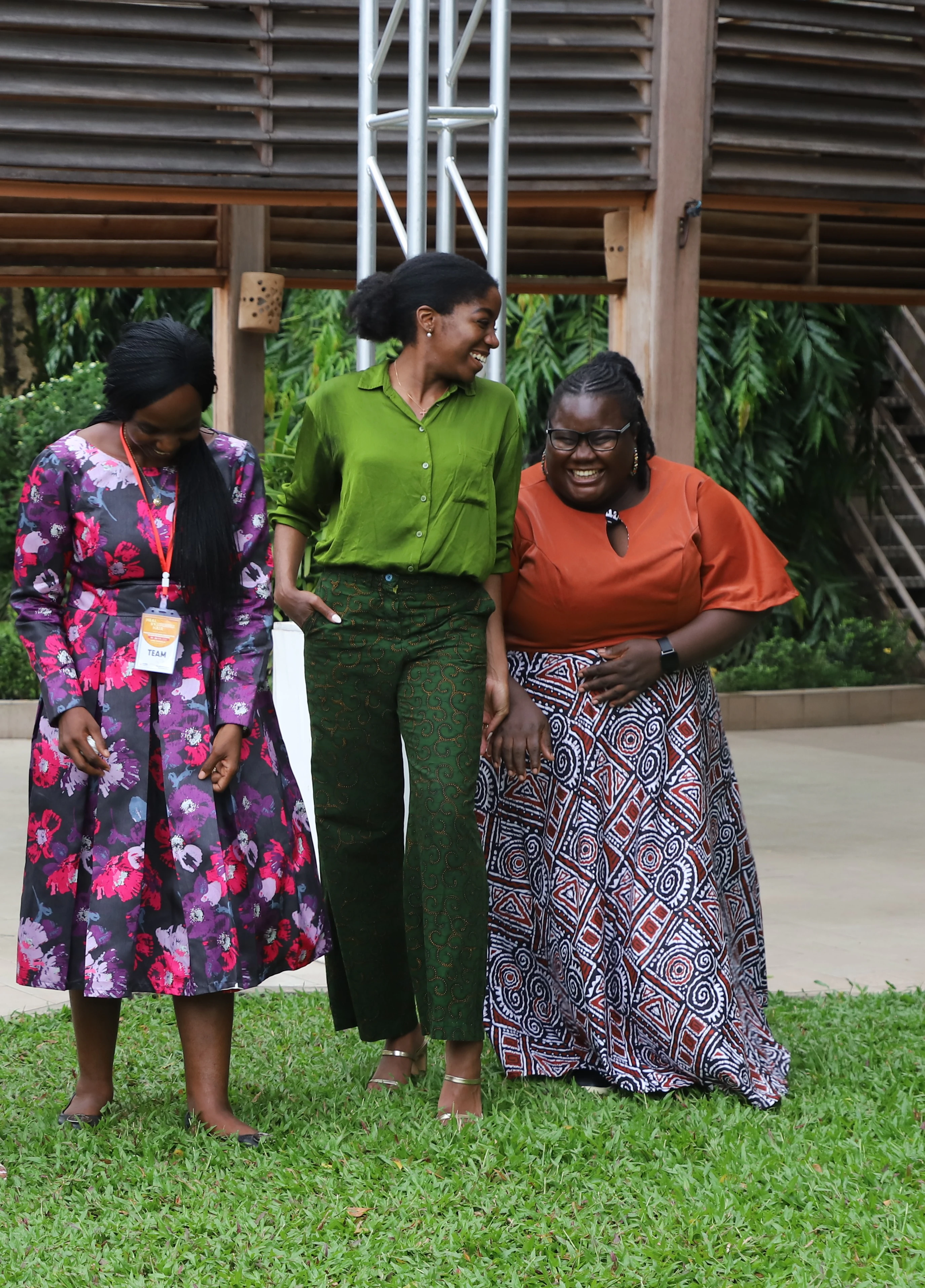 Three Bluemind Foundation team members sharing a joyful moment outdoors